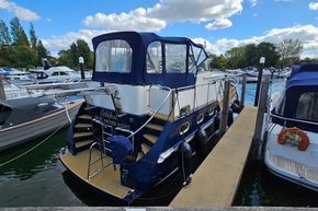 2005 Stevens 1200 Vlet docked at marina, featuring blue and white exterior.