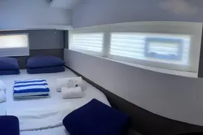 Luxurious cabin interior of 2022 Leopard 45 yacht with cozy bedding and soft lighting.