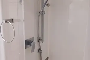 Modern shower with chrome fixtures in a 2017 Leopard 48 yacht bathroom.