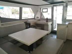 Modern interior of 2019 Leopard 45 catamaran with spacious seating and dining area.