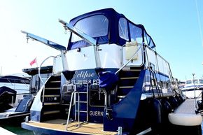 2005 Stevens 1200 Vlet yacht docked, featuring a blue and white exterior with canopy.