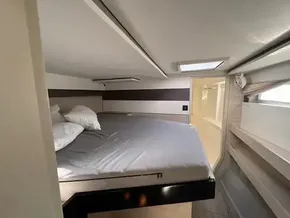 Cozy bedroom in 2020 Leopard 50 yacht with skylight and modern design.