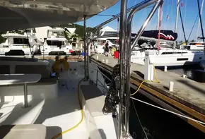 Lagoon 42 catamaran, 2020 model, docked at a marina with other boats in the background.