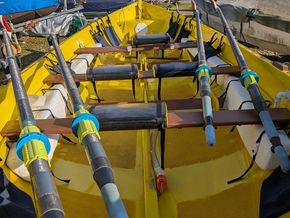 Bow internal view showing  oars and padded seats to all rowing positions