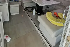 Interior of a 2016 Leopard 58 yacht with modern furnishings and a dining area.
