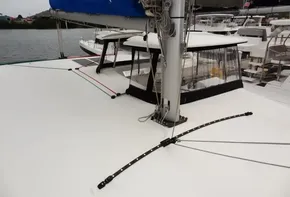 2020 Lagoon 42 catamaran deck with mast and sail, docked in marina.