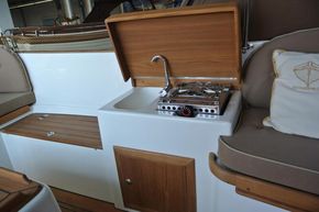 Interior of 2026 Enkhuizensloep 615 boat with compact kitchen and seating area.