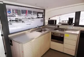Modern kitchen in 2017 Leopard 43 Powercat yacht with appliances and marina view.