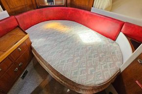 Interior of a 1989 Princess 35 Flybridge yacht with a cozy red and beige seating area.