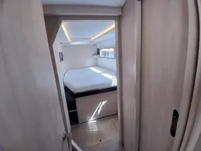 Cozy bedroom in 2019 Leopard 45 yacht with modern design and natural lighting.