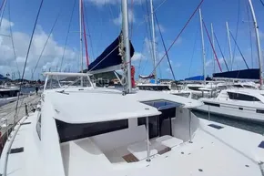 2017 Leopard 48 catamaran docked at marina under clear blue sky.