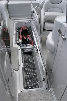 Crownline Deck Boat 262 EX - Convenient wakeboard storage between driver and passenger seats