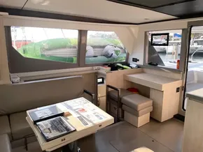 Modern interior of 2021 Leopard 45 catamaran with dining area and large windows.