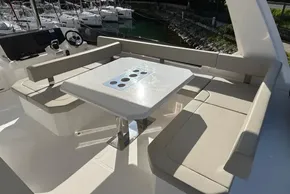 2024 Leopard 40 Powercat seating area with table, featuring modern design and comfortable beige cushions.