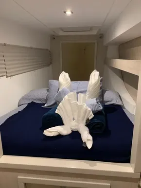 Leopard 40 2020 model cabin with neatly arranged bed and towel art.