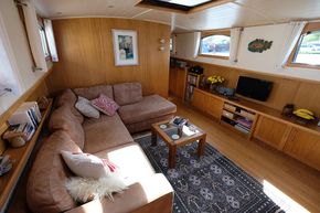 The comfortable saloon has large opening windows and leather corner settee