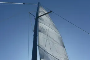 Sail of a 2017 Lagoon 42 catamaran against a clear blue sky.
