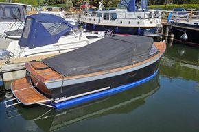 2008 Menken Maritiem The Cab motor yacht docked, covered with a black tarp.