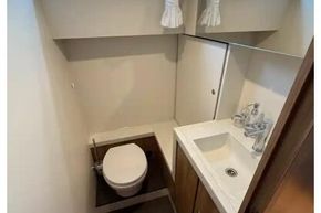 Bathroom interior of 2025 Linssen 45 SL Sedan yacht, featuring toilet and sink.