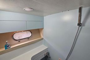 Interior of 1989 Princess 35 Flybridge yacht bathroom with shower and window.