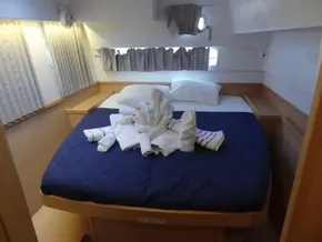 2020 Lagoon 42 yacht cabin with neatly arranged towels on a cozy bed.