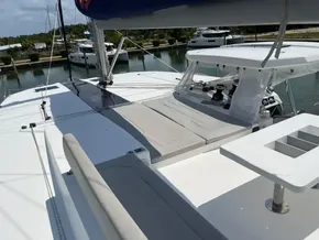 Leopard 50 catamaran 2020 model, spacious deck with seating and sunbathing area, docked at marina.