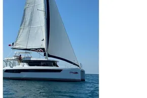 2022 Leopard 42 catamaran sailing on open sea under clear blue sky.