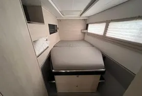 Compact bedroom in 2019 Leopard 45 catamaran with modern design and natural light.