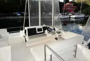 Interior helm station of 2018 Leopard 43 Powercat with navigation equipment and waterfront view.