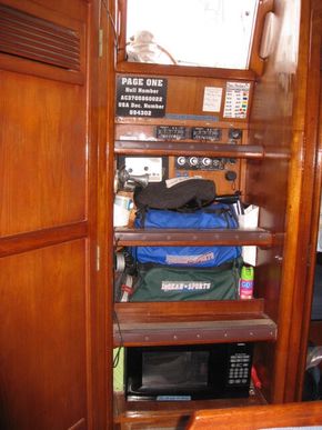 The Companionway provides room for Go Bags, a fire extinguisher, EPIRBS, Controls for Solar Panel and Air Conditioner, as well as,  storage for House Batteries below.