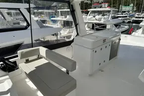 2025 Robertson and Caine Leopard 46 Powercat interior with seating and marina view.