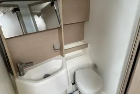 Modern bathroom in 2023 Beneteau Oceanis 51.1 yacht, featuring compact sink and toilet.