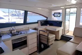 Luxurious 2017 Leopard 48 yacht interior with modern kitchen and seating, overlooking marina.