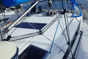 2019 Jeanneau Sun Odyssey 440 sailboat with blue sail cover, docked in marina.