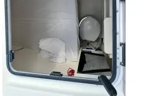 Interior cabin view of 2021 Leopard 50 yacht, featuring bed and compact bathroom.