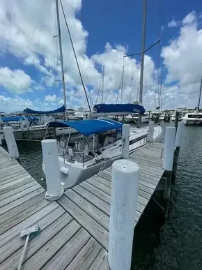2017 Jeanneau Sun Odyssey 519 sailboat docked at a marina under a blue sky.