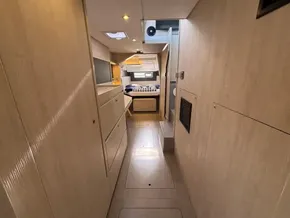 Interior of a 2019 Leopard 40 catamaran, featuring a cozy cabin with modern wood finishes.