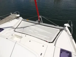 2021 Leopard 40 catamaran with netting on deck, docked by calm water.