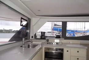 Interior of 2017 Leopard 45 yacht kitchen with modern appliances and marina view.