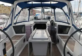 2019 Beneteau Oceanis 41.1 yacht cockpit with dual steering wheels and blue canopy.