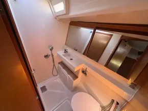 Bathroom interior of 2019 Jeanneau Sun Odyssey 440 yacht, featuring modern fixtures and mirror.