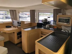 Interior of 2020 Lagoon 42 catamaran with modern kitchen and navigation station.