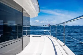 2025 Leopard 40 Powercat yacht cruising on open sea with city skyline in background.