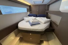 Luxurious cabin interior of 2024 Leopard 40 Powercat with neatly arranged bedding.