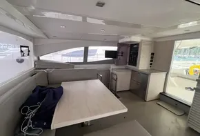 Interior of 2019 Leopard 51 Powercat yacht with modern seating and kitchen area.