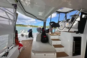 2024 Lagoon 42 catamaran interior with seating, steps, and ocean view.