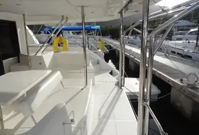 2017 Leopard 43 Powercat yacht docked at marina, featuring spacious deck and seating area.