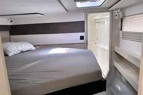 Modern bedroom interior in 2021 Leopard 50 yacht, featuring bed and ensuite bathroom.