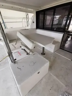 2017 Leopard 43 Powercat interior seating area with table and storage compartments.
