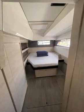Modern cabin interior of a 2020 Leopard 50 yacht with a cozy bed and sleek design.